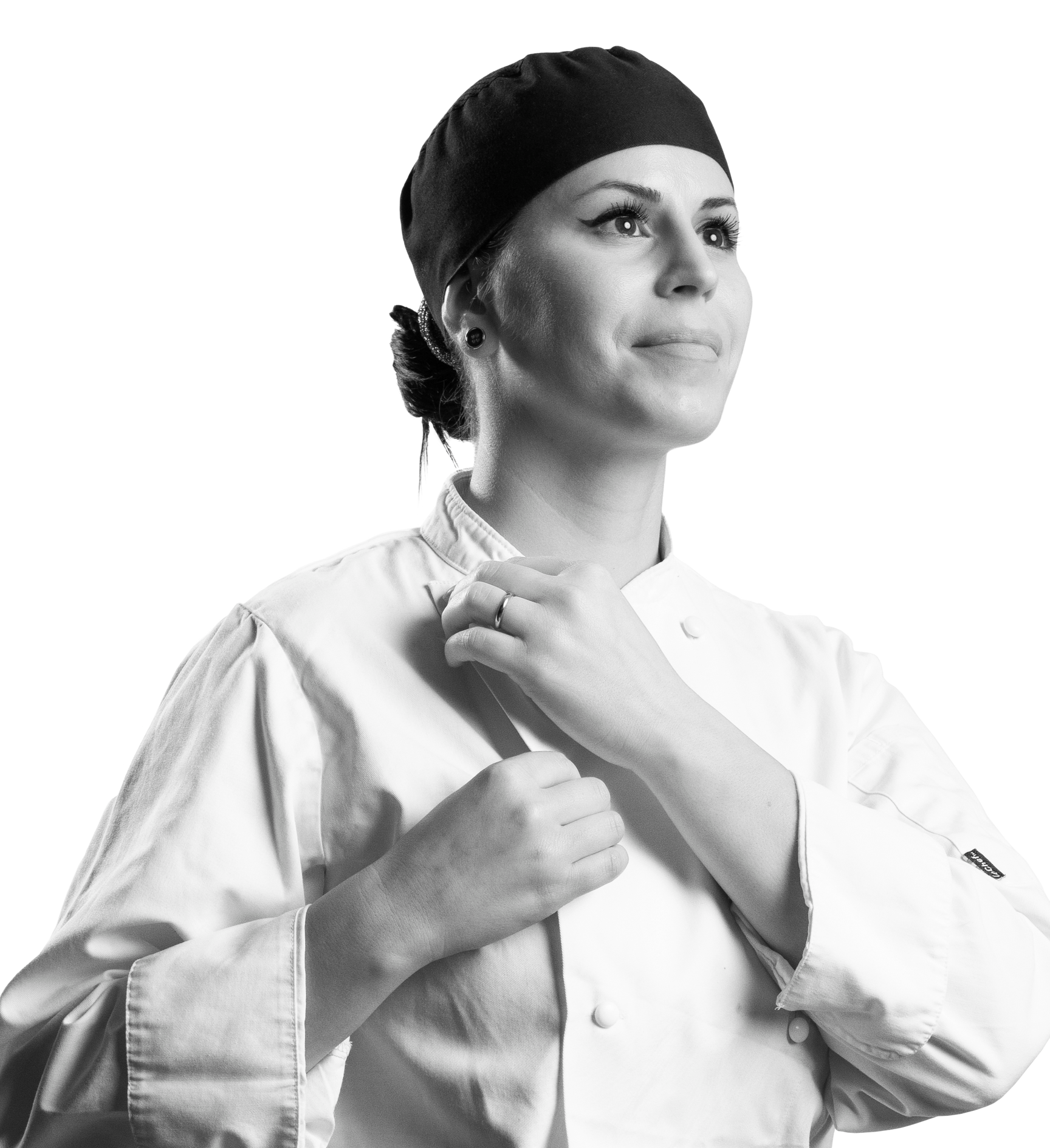 Black and white photo of woman buttoning chef's uniform